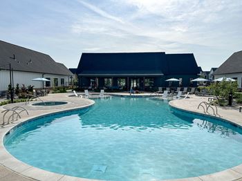A large swimming pool with a building in the background